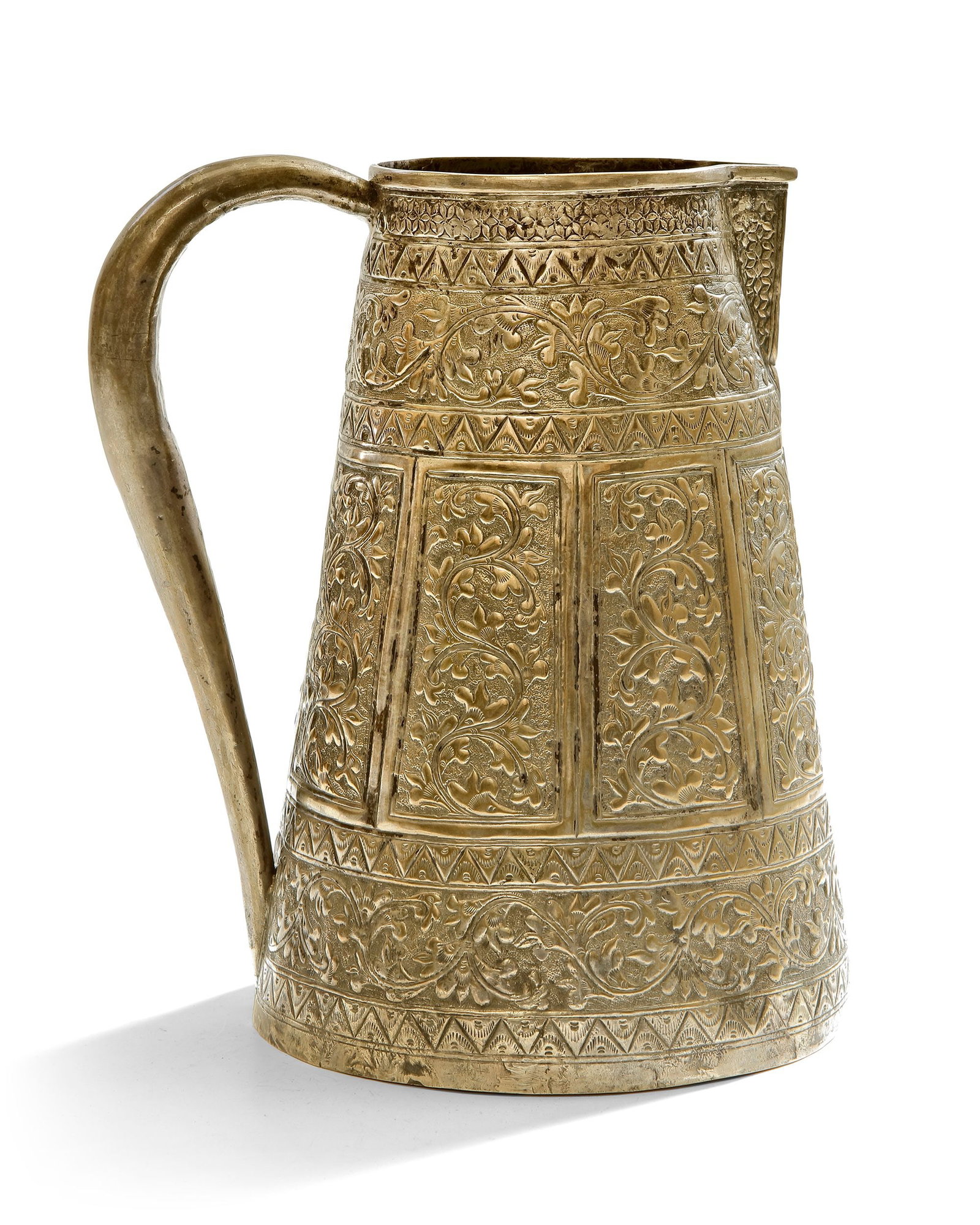 A MALAY SILVER JUG, 19TH CENTURY: Decorated with intricate floral and geometric engravings in traditional style. Height 20 cm. Diam 14 cm. THE DR. SAAD AL-JADIR COLLECTION