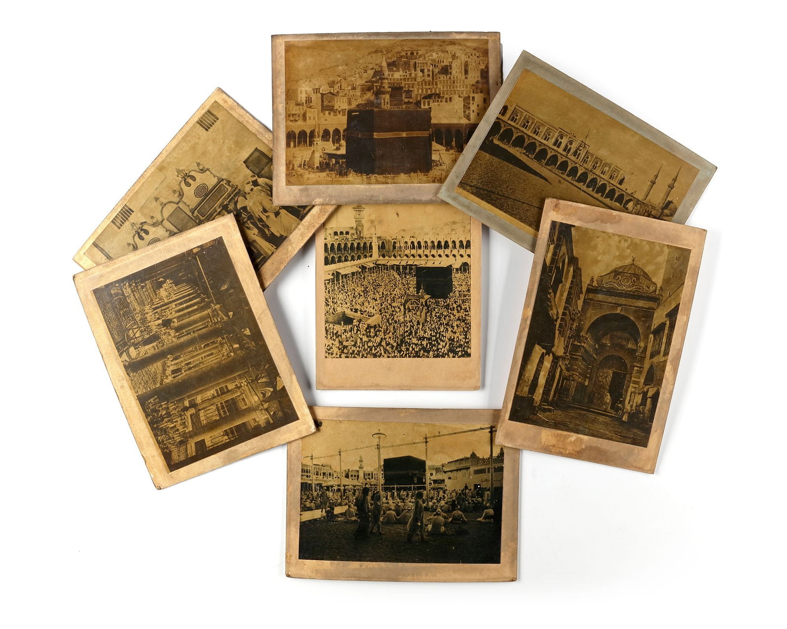 A COLLECTION OF EIGHT OLD PHOTOGRAPHS OF MECCA, MEDINA AND THE HAJJ, EARLY 20TH CENTURY: Images of Mecca with prayers around the Kaaba, an inside view of al-Masjid al-Nabawi, a view of Mecca with the kaaba in the foreground and ramy al-jamarat at Muna. Approximately: 13 by 18 cm.