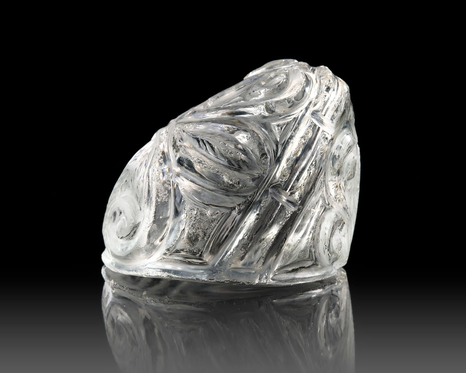 ROCK CRYSTAL CHESS PIECE, 11TH CENTURY: Carved with deep bevel-cut foliate designs and incised dash details. Height 4 cm. PROVENANCE Private collection, Belgium. CATALOGUE NOTE The game of chess, which can be traced back through archaeologi