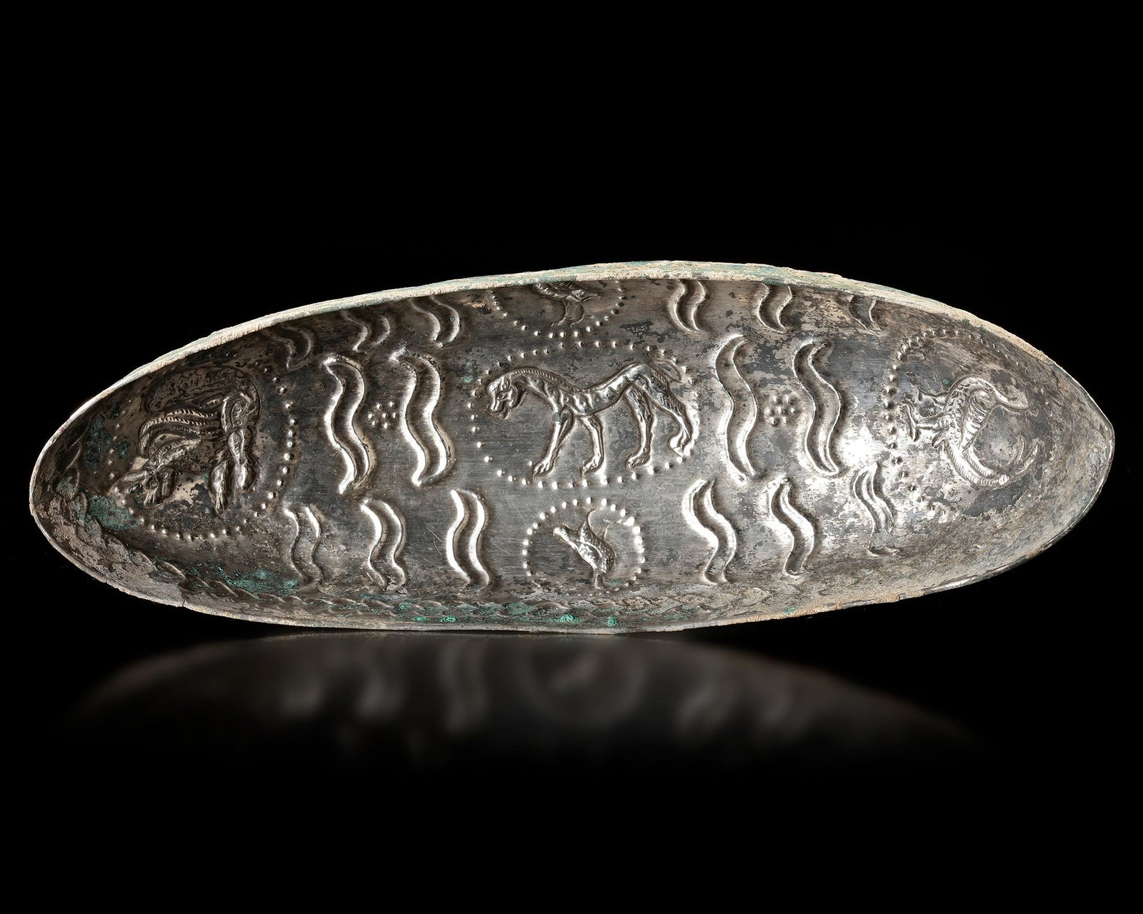 A SASANIAN SILVER BOWL CIRCA 5TH-7TH CENTURY AD: A finely crafted Sasanian silver bowl dating to the 5thâ€“7th century AD, decorated with repouss?© animal motifs including a central horse and surrounding creatures. The surface is enriched w