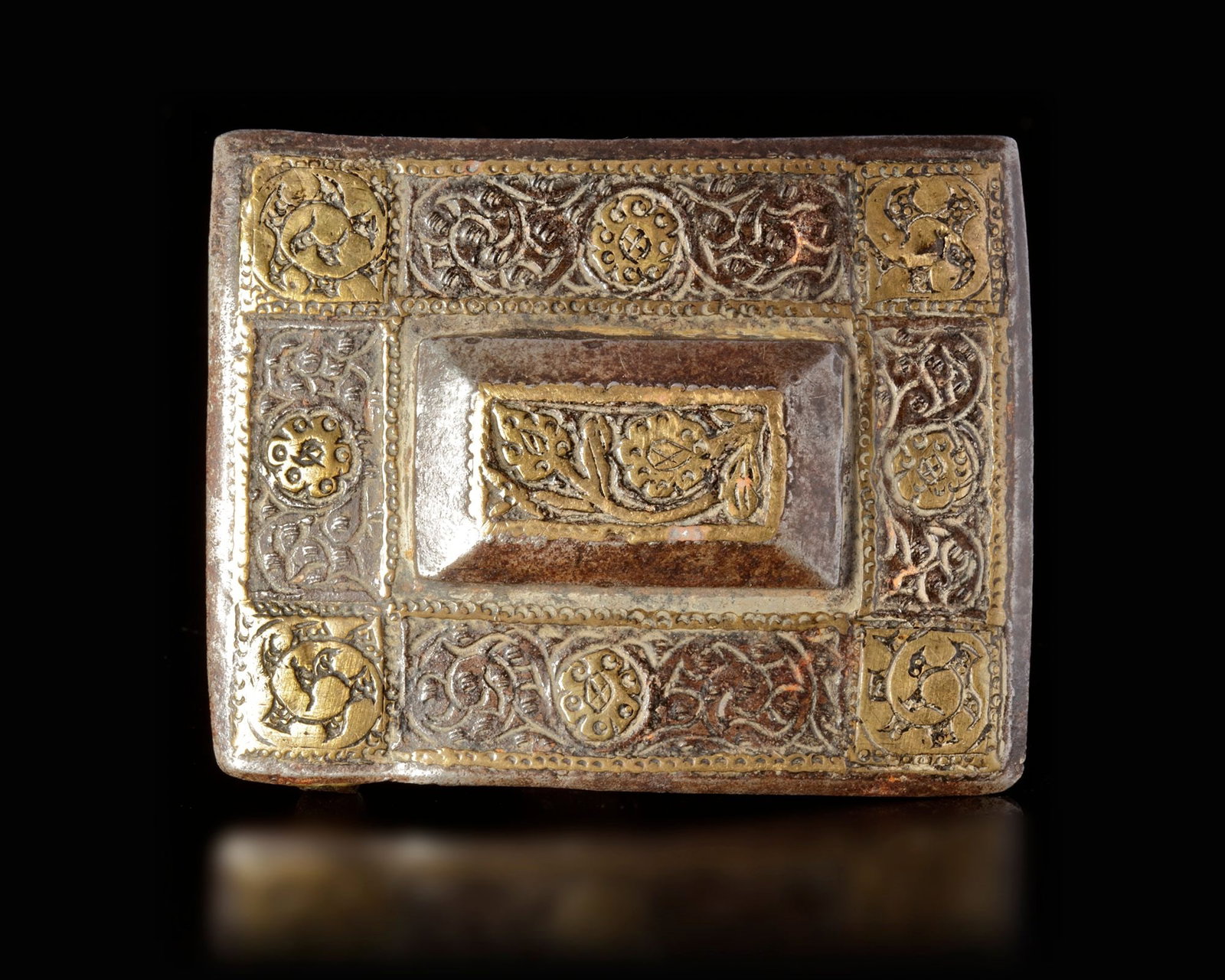 A QAJAR GILT BRONZE PIERCED BELT BUCKLE, PERSIA, 19TH CENTURY: Finely pierced with gilt interlocking floral scrolls. 7,5 by 6,5 cm.