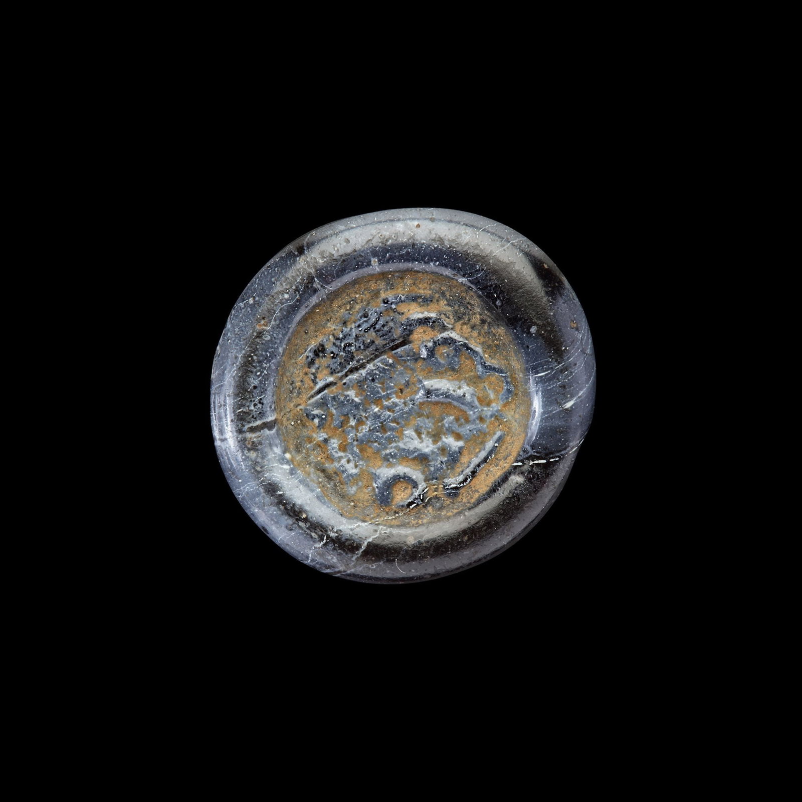 AN EARLY ISLAMIC GLASS WEIGHT OF HALF DIRHAM, 10TH-11TH CENTURY: Glass weight, moulded and stamped, opaque dark-violet in colour, citing in the centre with " Ali al-Shaubah", 1.520g, 16 mm, coin weight: half dirham. LP 1891/339- N152