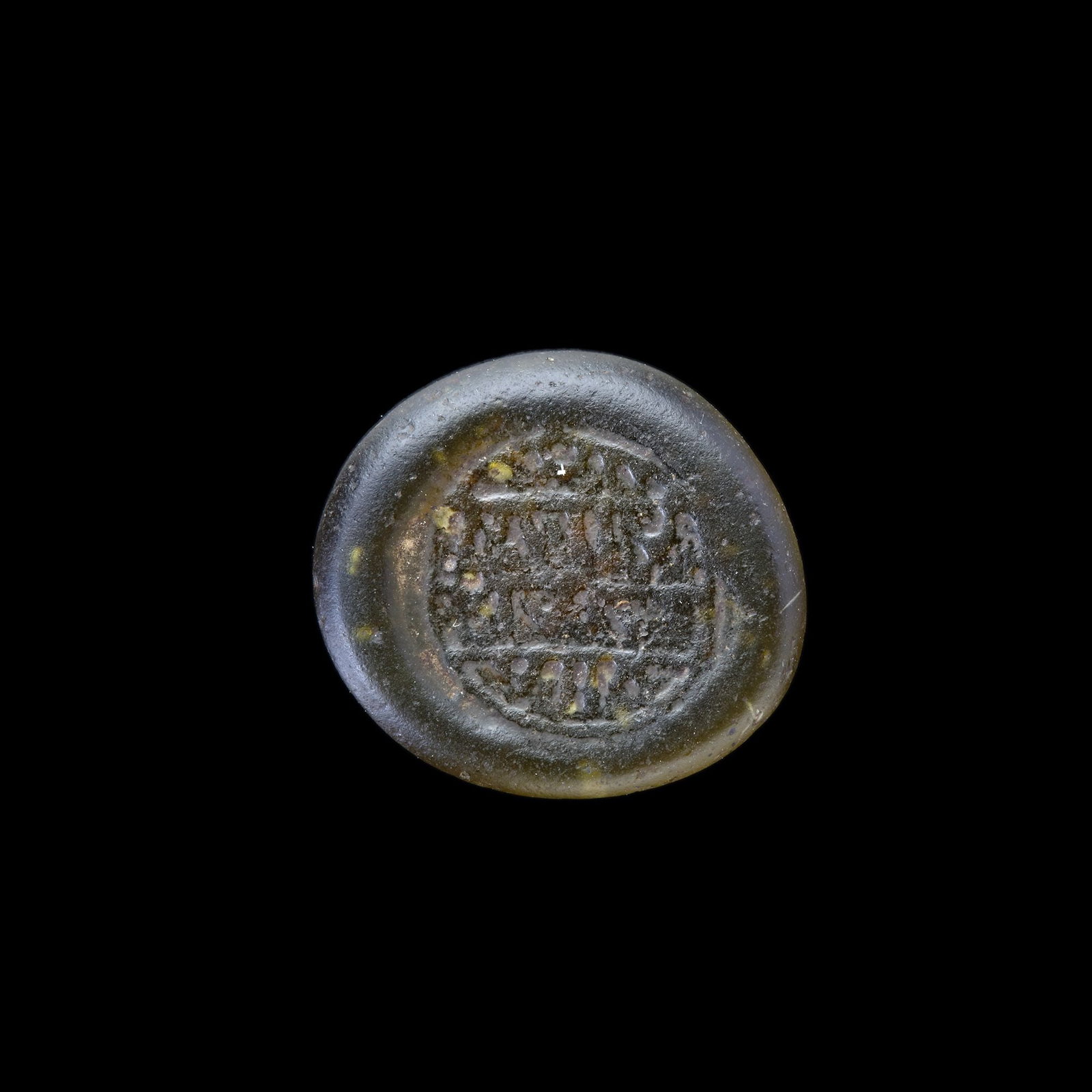 AN EARLY ISLAMIC GLASS WEIGHT OF DIRHAM 10TH-11TH CENTURY: Glass weight, moulded and stamped, transparent pale-green in colour, citing in the centre with 3 lines of undeciphered Arabic text. 2,951g, 20 mm. coin weight: dirham.