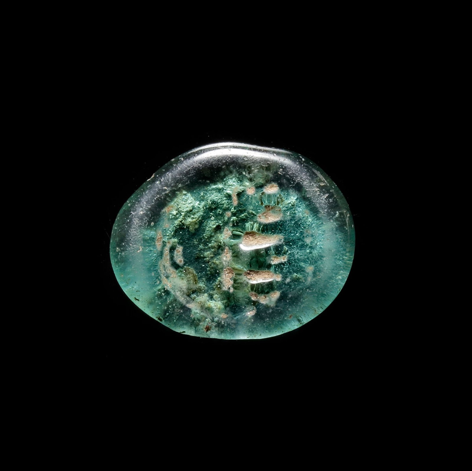 AN EARLY ISLAMIC GLASS WEIGHT OF DIRHAM, 10TH-11TH CENTURY: Glass weight, moulded and stamped, transparent green in colour, citing in the centre with 2 lines of undeciphered Arabic text. 2.391 g., 21 mm. coin weight: dirham.