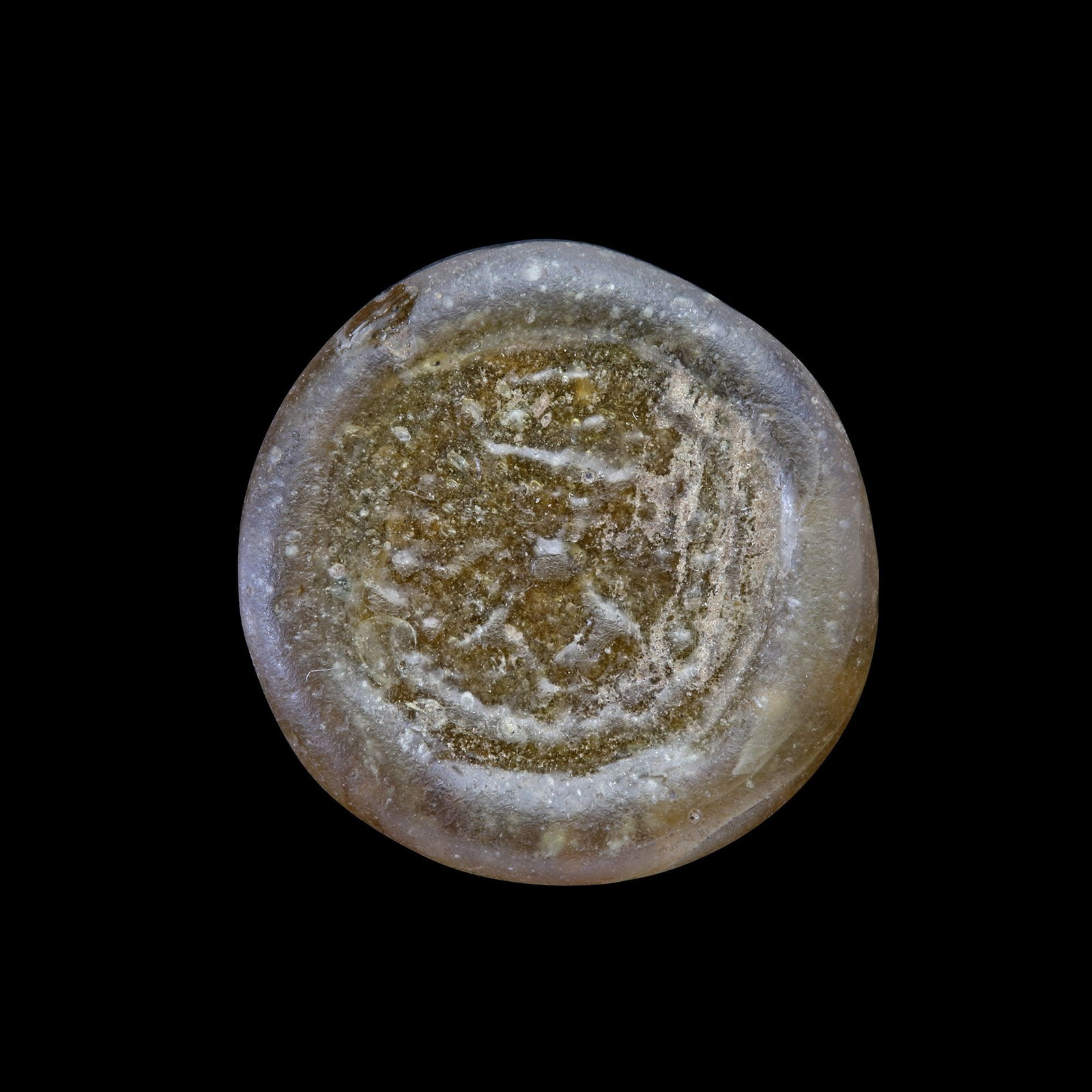 AN EARLY ISLAMIC GLASS WEIGHT OF DIRHAM, 10TH-11TH CENTURY: Glass weight, moulded and stamped, transparent brown in colour. 2.941 g., 20 mm. coin weight: dirham.
