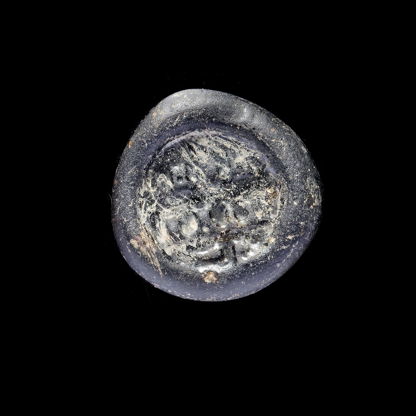 AN EARLY ISLAMIC GLASS WEIGHT OF DOUBLE DIRHAM, 10TH-11TH CENTURY: Glass weight, moulded and stamped, opaque brown in colour, citing in the centre with 3 lines of undeciphered Arabic text. 5.970 g., 26.2 mm. coin weight: double dirham. B 46, N133-4