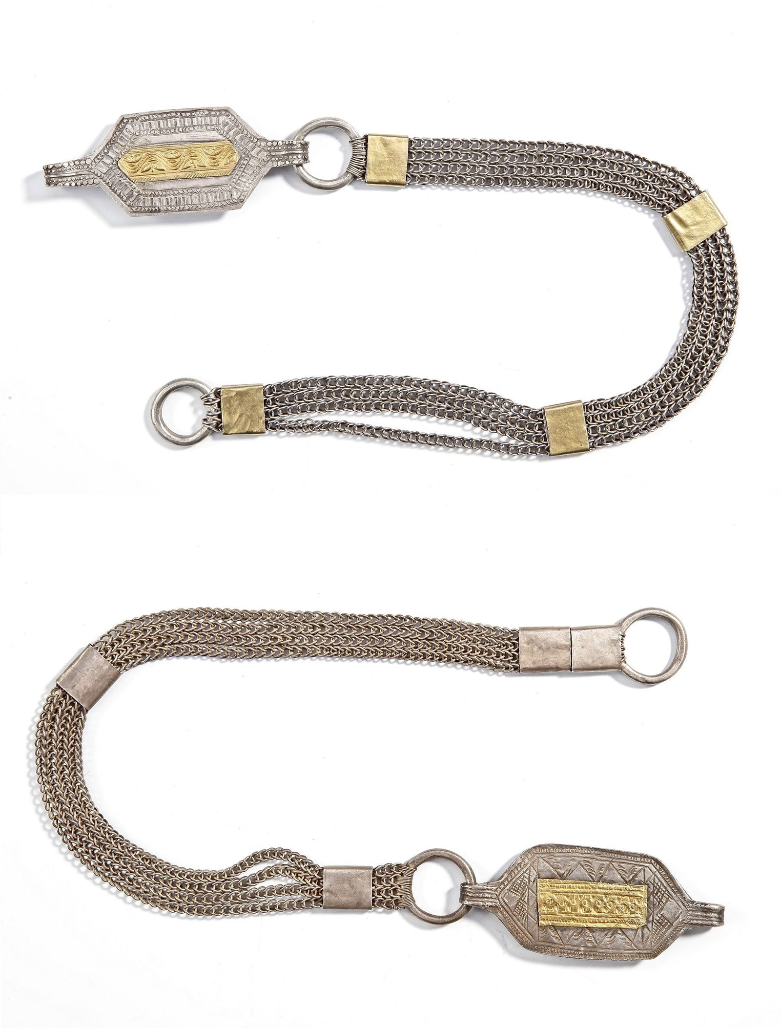 A PAIR OF SILVER BELTS, OMAN, 19TH CENTURY: 1- with multiple chain strands linked by rectangular gold-plated connectors. The central clasp is finely engraved with geometric and wave motifs, highlighted with gilt details. ca. 55 cm. 123 gr. 2- w