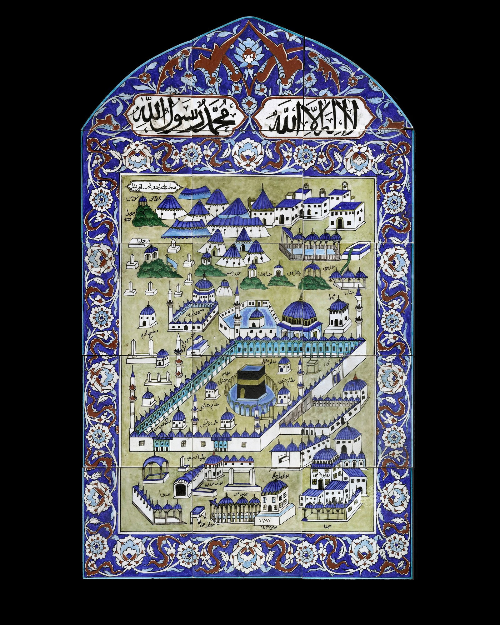 AN IZNIK-STYLE TILE PANEL KUTAHYA, TURKEY, 19TH CENTURY: A Mihraab shaped panel, comprised of 15 tiles, the white ground painted in turquoise, green, cobalt-blue and bole-red, with a stylized view of Mecca, with the black-shrouded Kaâ€?ba in the cente
