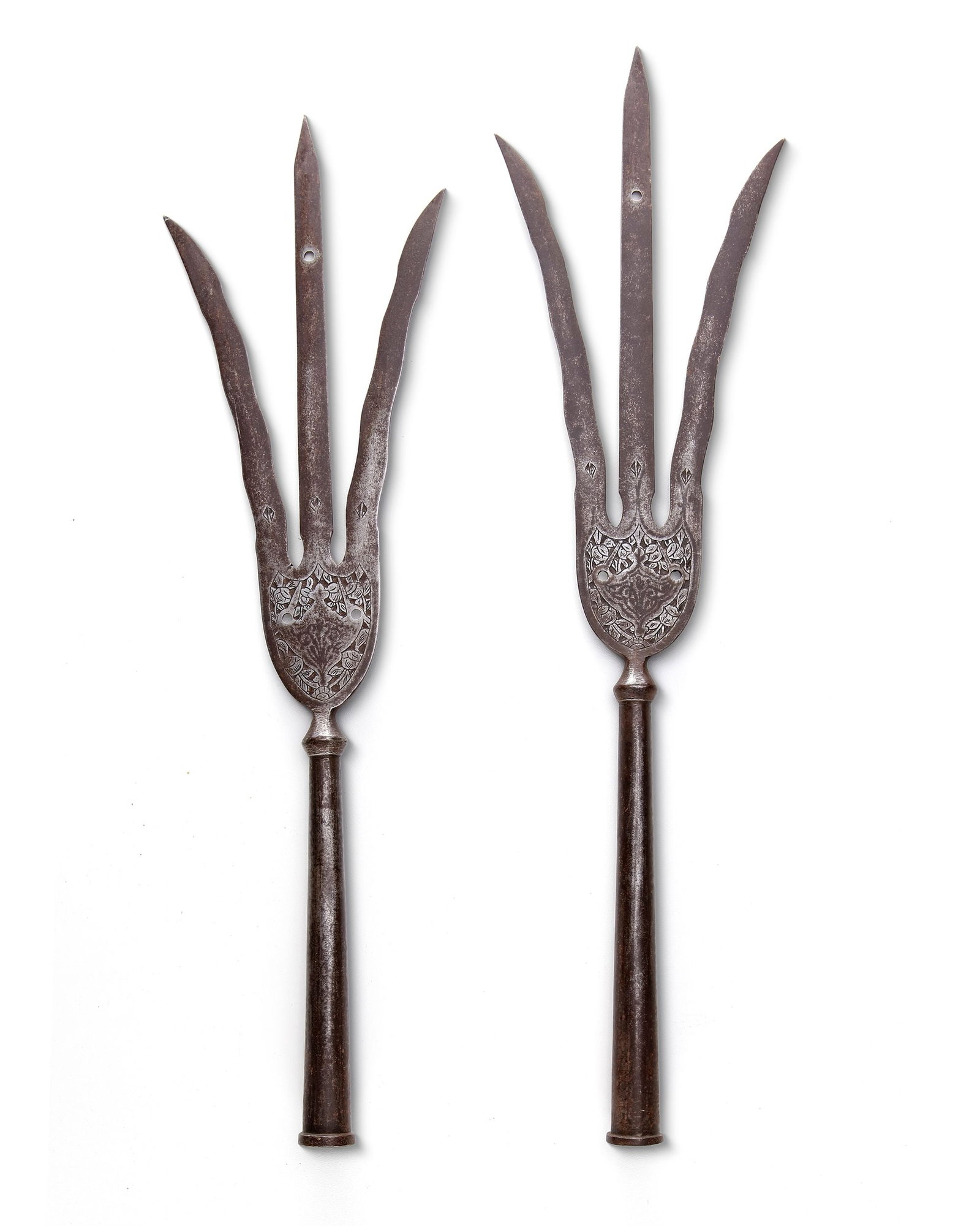 A PAIR OF INDO PERSIAN STEEL TRIDENT LANCE, 19TH CENTURY: A dense triangular midsection and a slender head terminating in a straight central prong flanked by two gently undulating prongs. At the base of each prong appears a small etched floral motif, while t