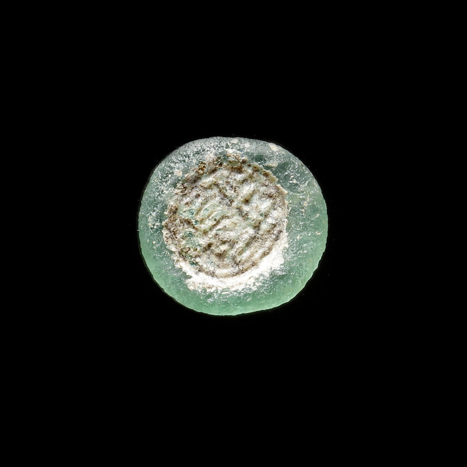 AN EARLY ISLAMIC GLASS WEIGHT OF HALF DIRHAM (1 of 3)