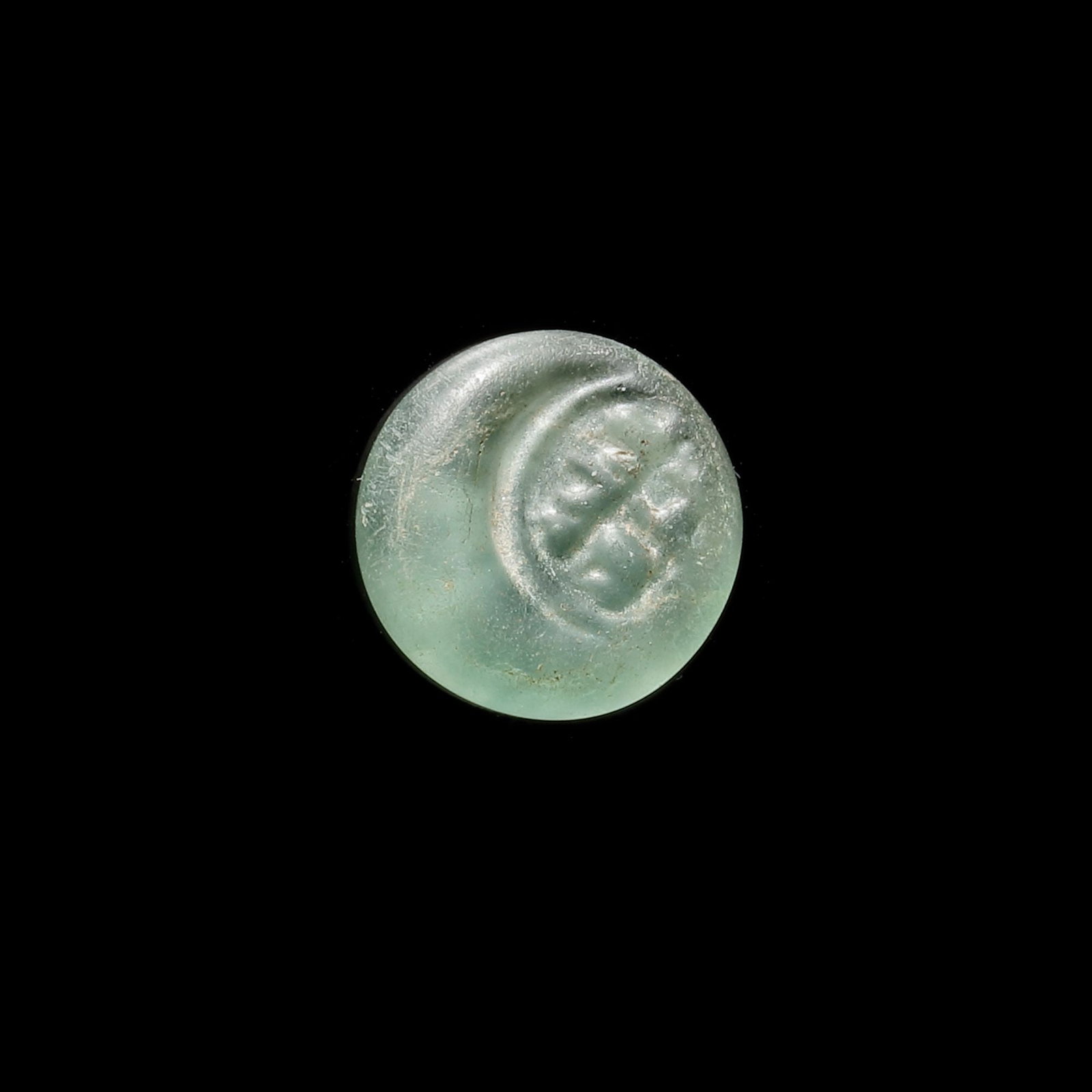 AN EARLY ISLAMIC GLASS WEIGHT OF HALF DIRHAM (1 of 3)