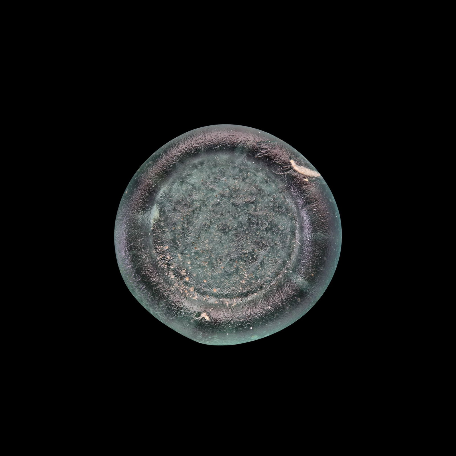 AN EARLY ISLAMIC GLASS WEIGHT OF HALF DIRHAM (1 of 2)