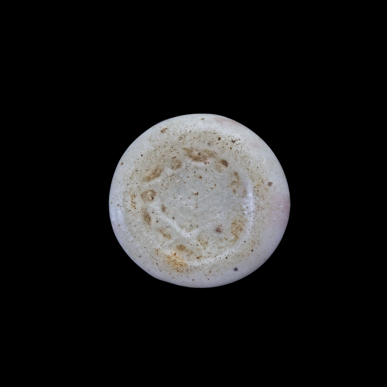AN EARLY ISLAMIC GLASS WEIGHT OF HALF DIRHAM, 10TH-11TH CENTURY: Glass weight, moulded and stamped, opaque white in colour, citing in the centre with the star of Solomon. 1.544g, 14 mm. coin weight: half dirham.