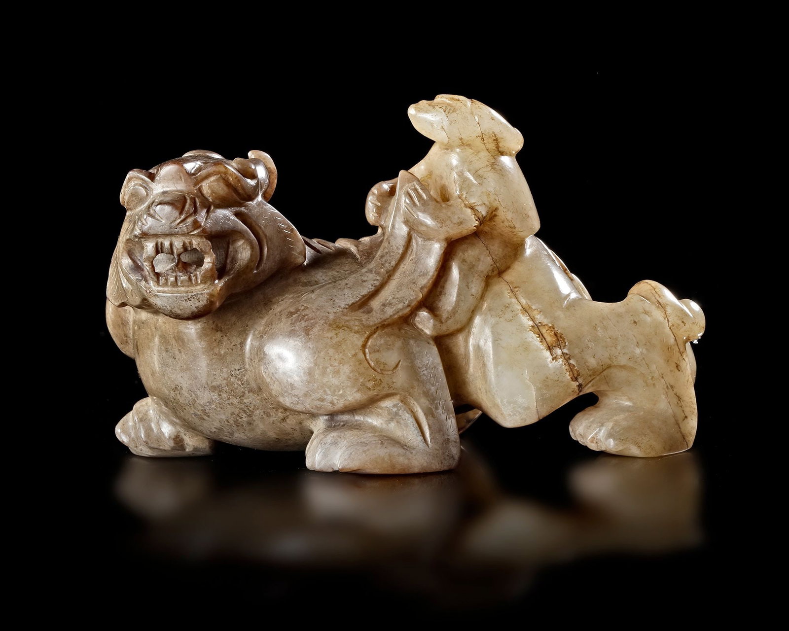 A CHINESE JADE OF AN IMMORTAL RIDING A BIXIE, HAN DYNASTY (206 BCâ€“220 AD) (1 of 5)