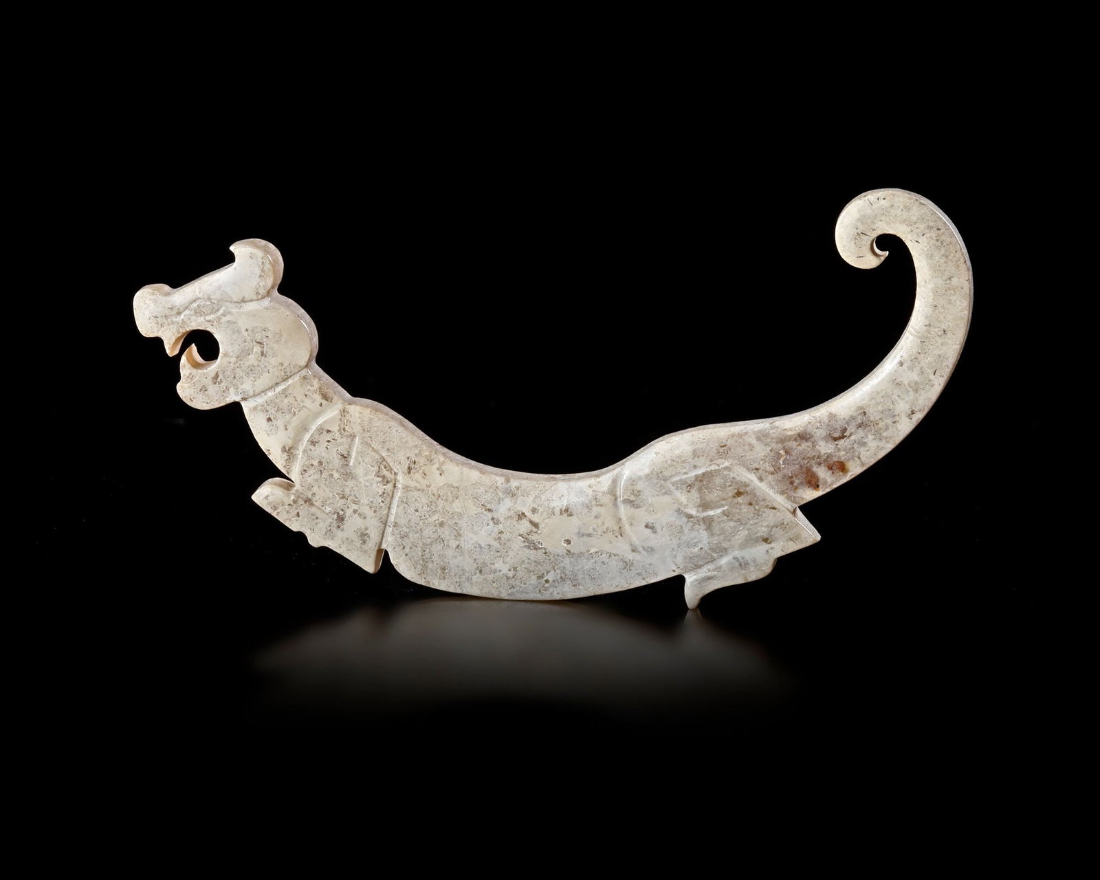 A CHINESE TIGER-SHAPED JADE PLAQUE, POSTâ€“SHIJIAHE CULTURE (c.2000 BC-1800 BC) (1 of 4)
