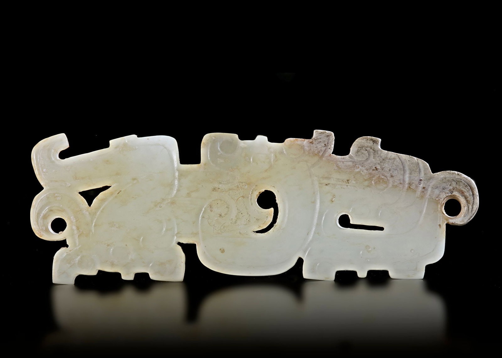 A JADE PENDANT, CHINA, ZHOU PERIOD (CIRCA 1046â€“256 BC): Pair of finely carved jade pendants featuring stylized animal motifs and decorative openwork. The translucent jade shows natural aging and patina. Length 7 cm. PROVENANCE Private collection mr. J.K., 