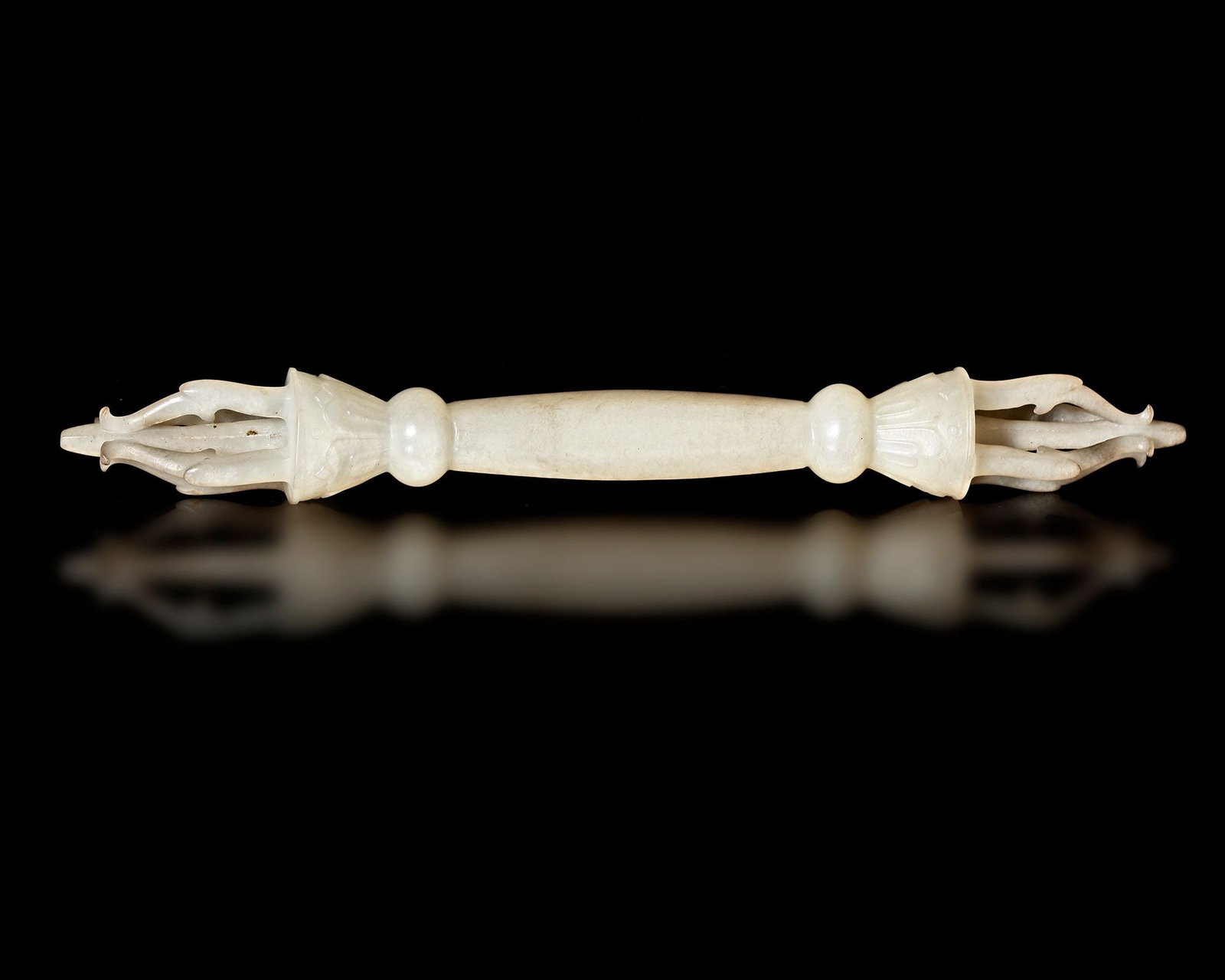 A WHITE JADE SCEPTER, CHINA, MING DYNASTY, (1368â€“1644): An elegant ceremonial scepter carved from white jade, dating to the Ming Dynasty. The piece features a slender shaft with finely carved terminals and delicate openwork elements .Such scepters were oft