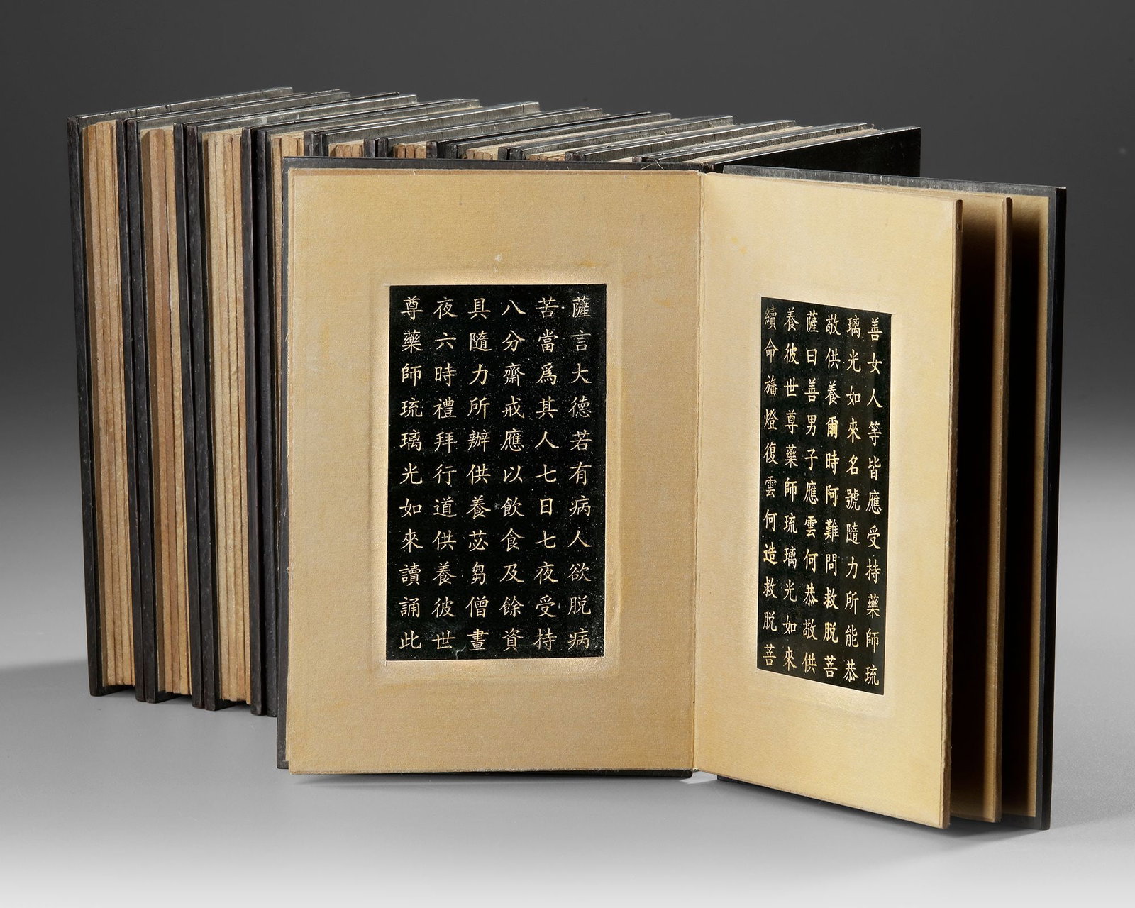 A JADE BUDDHIST SUTRA BOOK, QING DYNASTY (1644â€“1912): A rare Buddhist sutra book carved from jade, consisting of eleven rectangular pages engraved with finely cut Chinese characters. Each tablet is worked recto and verso, presenting sacred Buddhist scrip