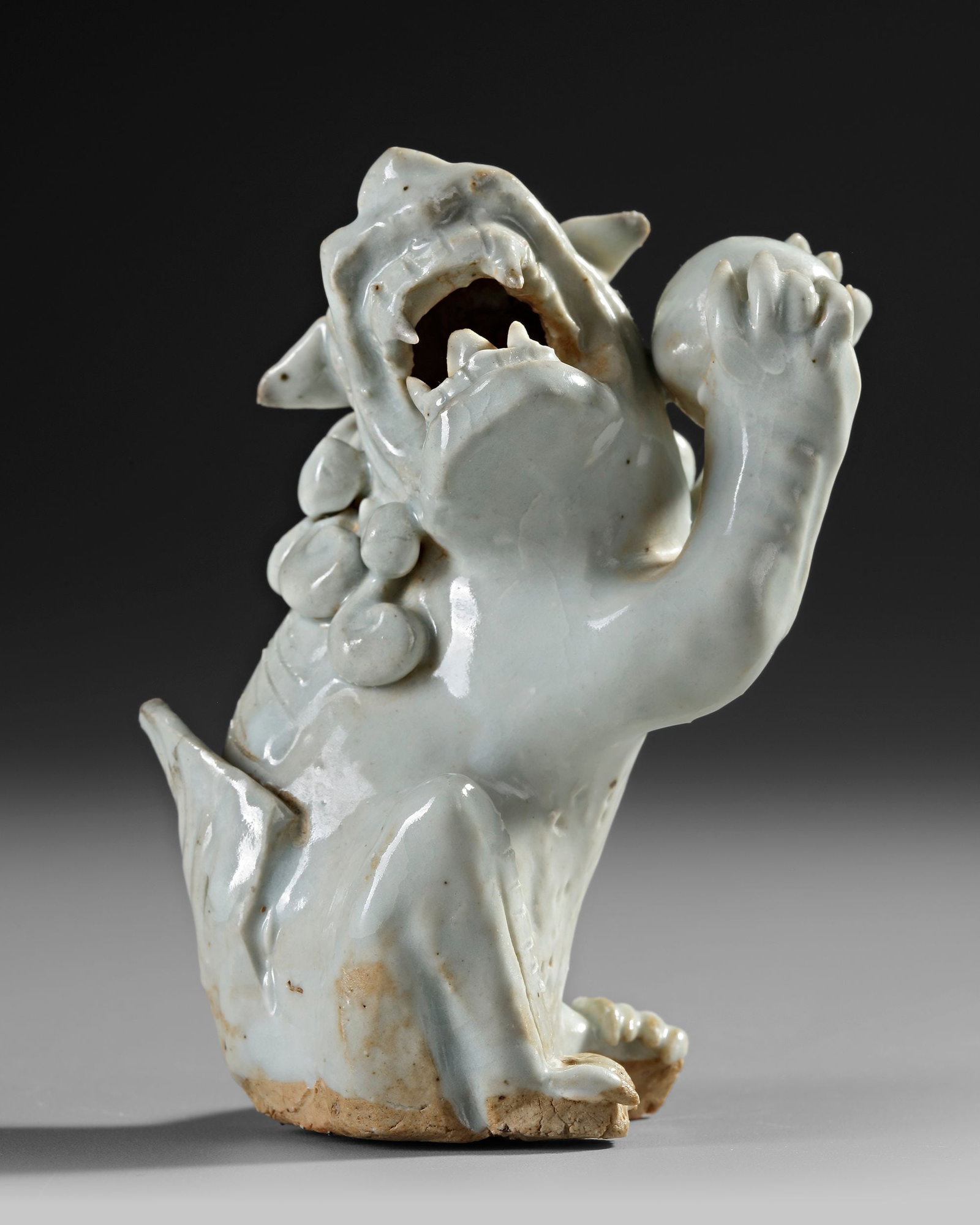 A CHINESE QINGBAI-GLAZED MYTHICAL BEAST, SONG DYNASTY (960-1279) (1 of 4)