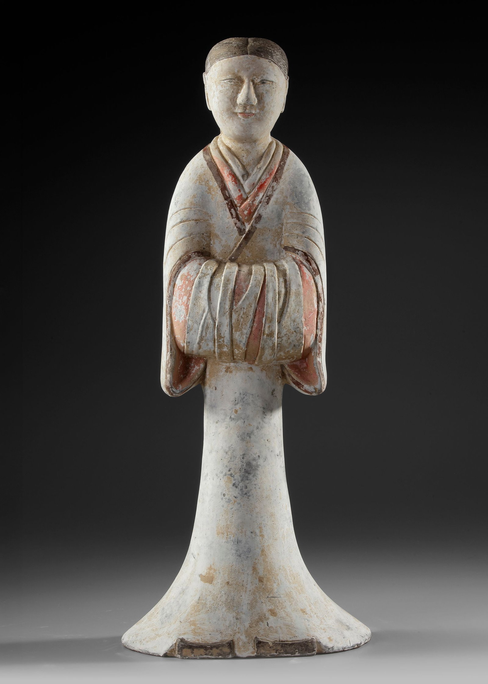 A LARGE TERRACOTTA STATUE OF A STANDING FEMALE ATTENDANT, CHINA, HAN DYNASTY (206 BC-206 AD): H. 59 cm. Wearing a long typical robe, with sleeves folded in front. Height Oxford TL tested. Provenance: Private collection, The Netherlands.