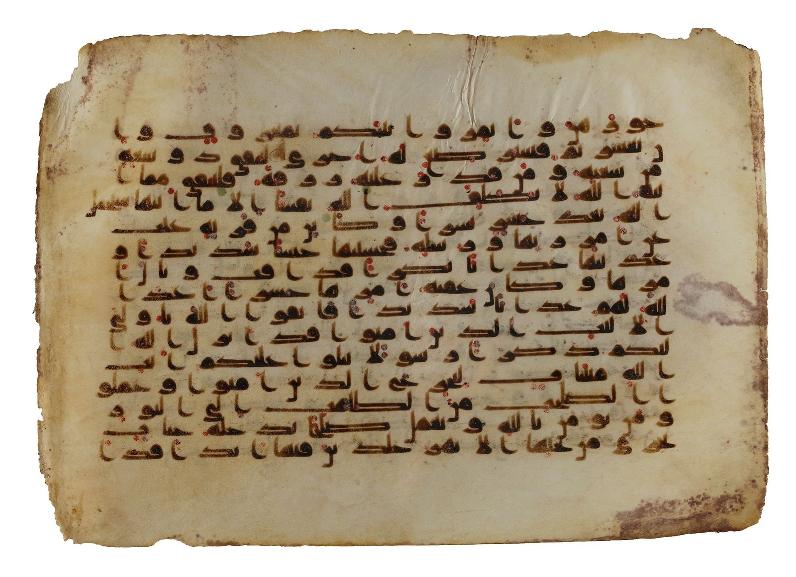 A QURAN FOLIO IN KUFIC SCRIPT ON VELLUM, NEAR EAST OR NORTH AFRICA, 9TH CENTURY: Arabic manuscript on vellum, 15 lines to the page written in elongated Kufic in dark brown ink, vocalization in the form of red dots, verses separated by small triangular clusters of three gold dots. 