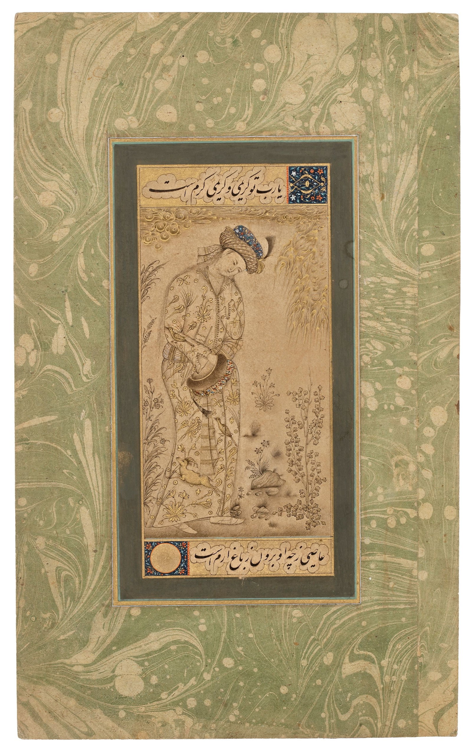 A YOUTH, PERSIA QAJAR, 19TH CENTURY: Ink and gouache, heightened with gold, on paper, depicting a standing youth in an elegant, introspective pose. The slender figure wears a long, finely patterned robe and a decorated turban, holding a 
