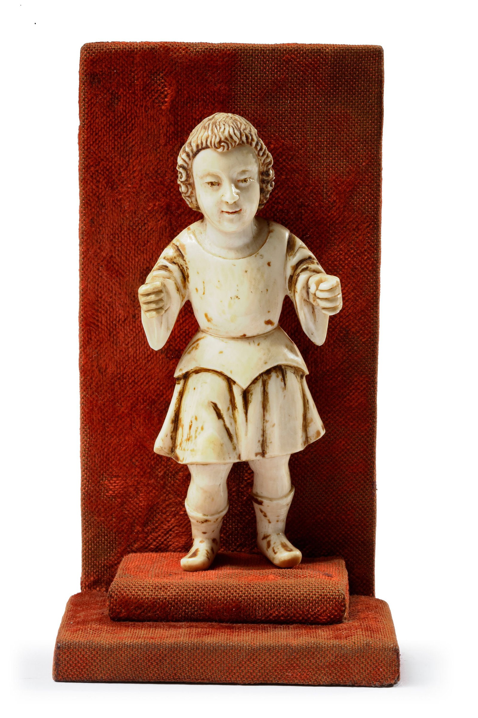 AN INDO-PORTOGUESE CARVING OF INFANT JESUS AS KRISHNA, GOA, 17TH-18TH CENTURY: A carving of infant Jesus Christ, with some characteristics of Krishna (the curly hair and the dress). Height 10.5 cm.