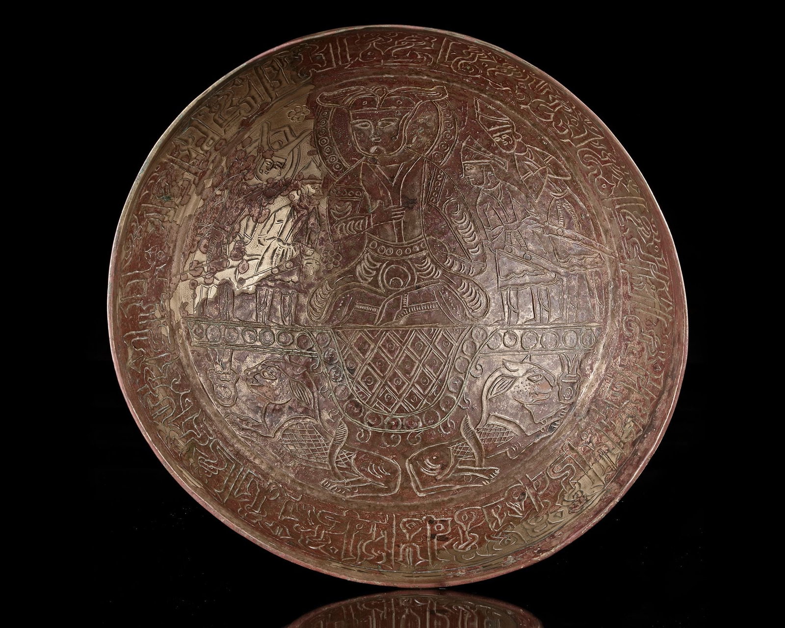 AN IMPORTANT AND LARGE GHAZNAVID FIGURAL HIGH-TIN BRONZE CAULDRON, PERSIA, 11TH CENTURY: Of hemispherical form, the interior finely incised with a central seated figure of a ruler, flanked by armed warriors to either side. around the inner rim runs a band of floriated kufic inscription. T