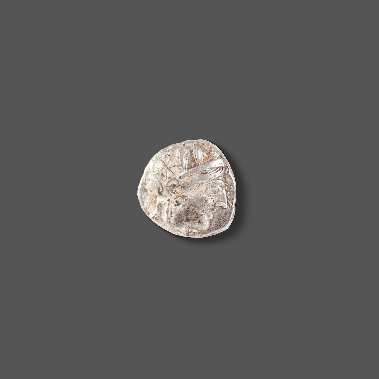 ATHENIAN SILVER TETRADRACHM ATTICA, ATHENS, CIRCA 465â€“454 BC: A classic ancient Athenian silver tetradrachm featuring the helmeted head of Athena on the obverse and the iconic owl of Athens on the reverse, accompanied by an olive sprig and crescent. Struck durin