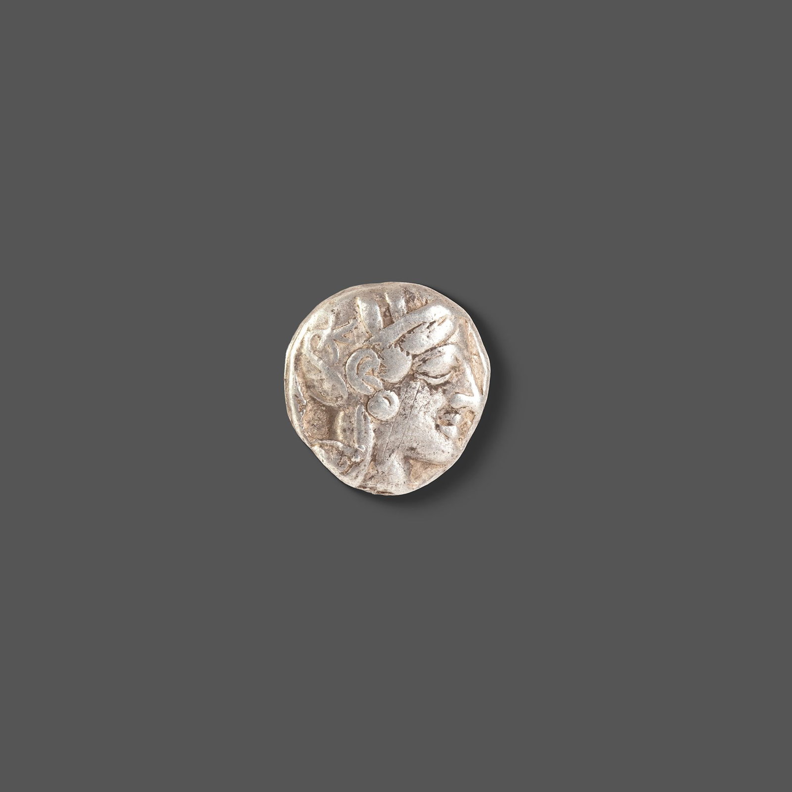 ATHENIAN SILVER TETRADRACHM ATTICA, ATHENS, CIRCA 465â€“454 BC: A classic ancient Athenian silver tetradrachm featuring the helmeted head of Athena on the obverse and the iconic owl of Athens on the reverse, accompanied by an olive sprig and crescent. Struck durin