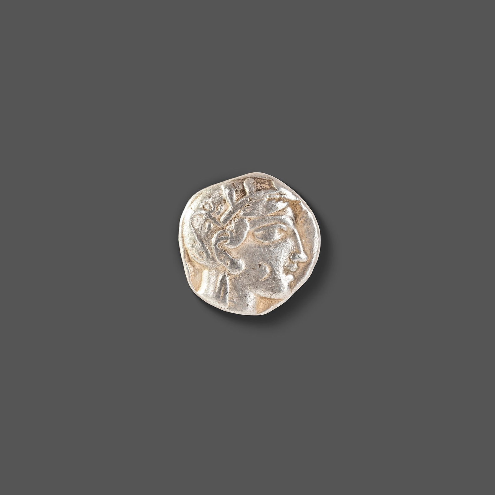 ATHENIAN SILVER TETRADRACHM ATTICA, ATHENS, CIRCA 465â€“454 BC: A classic ancient Athenian silver tetradrachm featuring the helmeted head of Athena on the obverse and the iconic owl of Athens on the reverse, accompanied by an olive sprig and crescent. Struck durin
