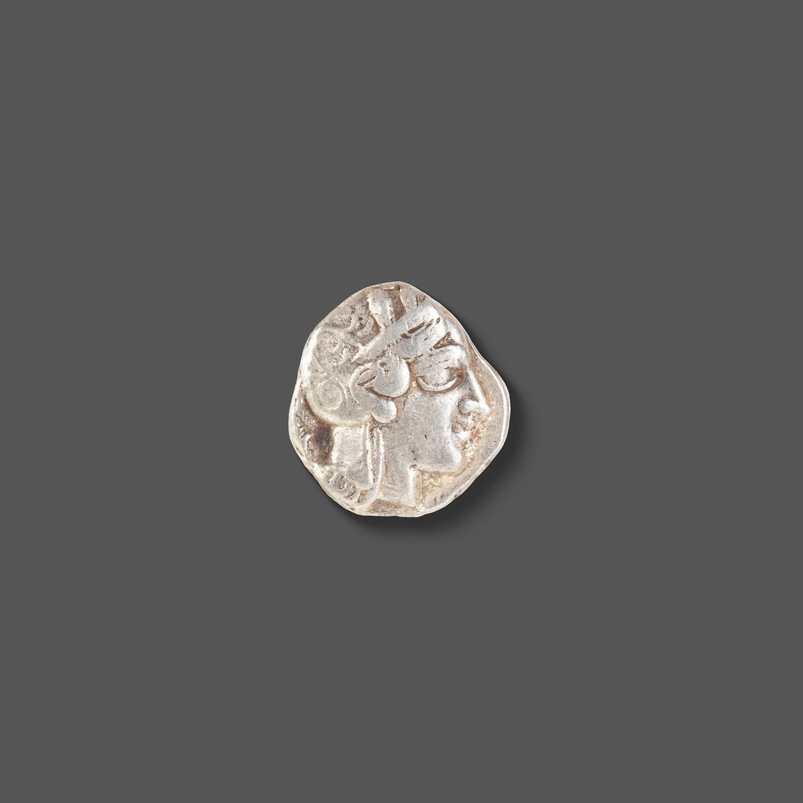 ATHENIAN SILVER TETRADRACHM ATTICA, ATHENS, CIRCA 465â€“454 BC: A classic ancient Athenian silver tetradrachm featuring the helmeted head of Athena on the obverse and the iconic owl of Athens on the reverse, accompanied by an olive sprig and crescent. Struck durin