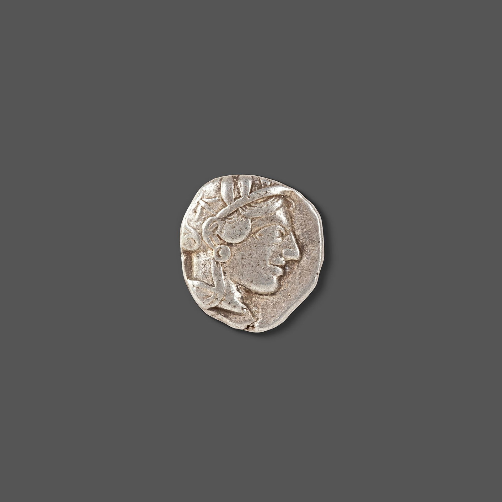 ATHENIAN SILVER TETRADRACHM ATTICA, ATHENS, CIRCA 465â€“454 BC: A classic ancient Athenian silver tetradrachm featuring the helmeted head of Athena on the obverse and the iconic owl of Athens on the reverse, accompanied by an olive sprig and crescent. Struck durin