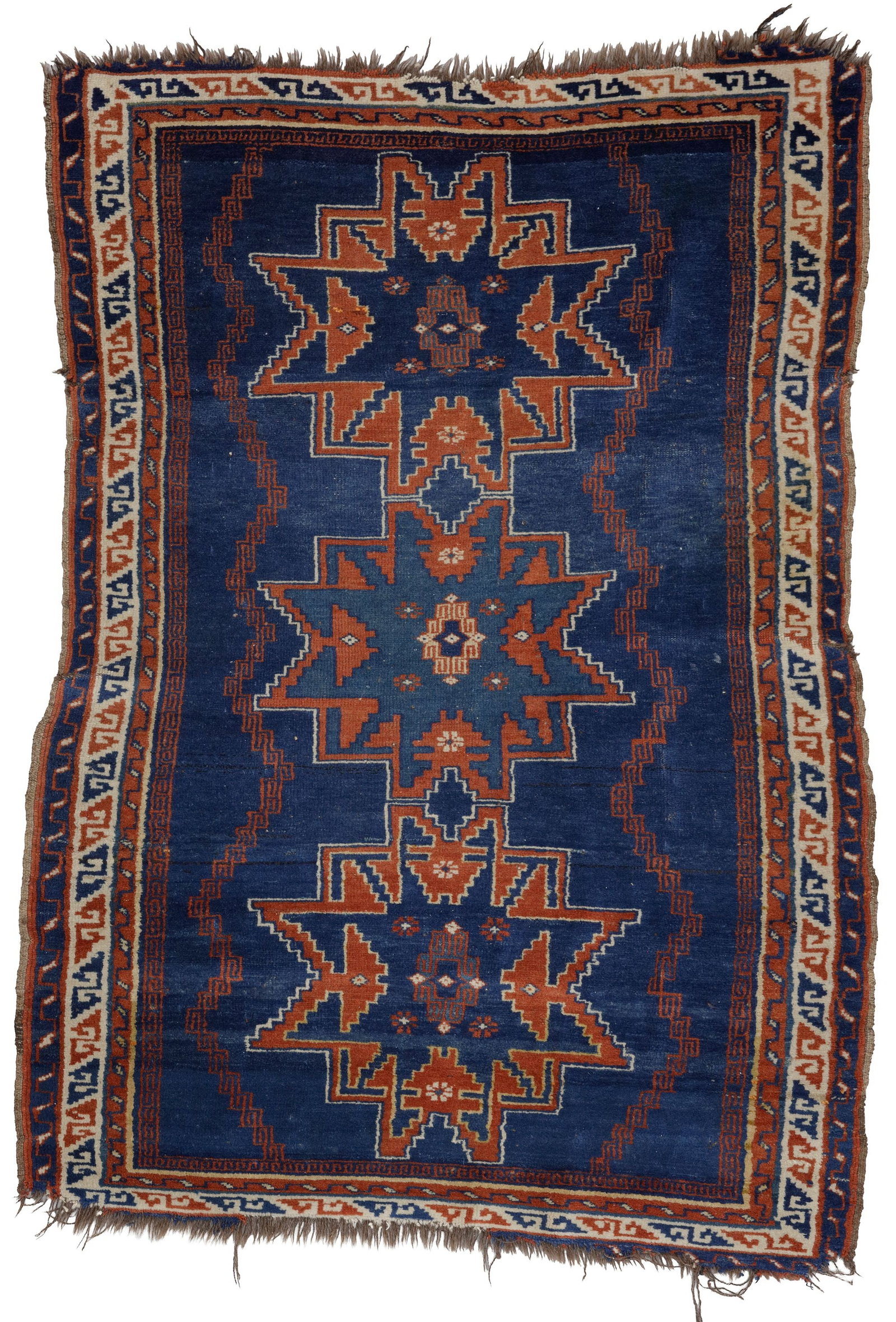 AN ANTIQUE CAUCASIAN SHIRVAN RUG WITH THREE STAR MEDALLIONS: Up for auction is a characterful and color-intensive antiquity of Caucasian knotting art: An antique Shirvan rug from the Eastern Caucasus, hand- knotted around 1900. This rug captivates with its arch