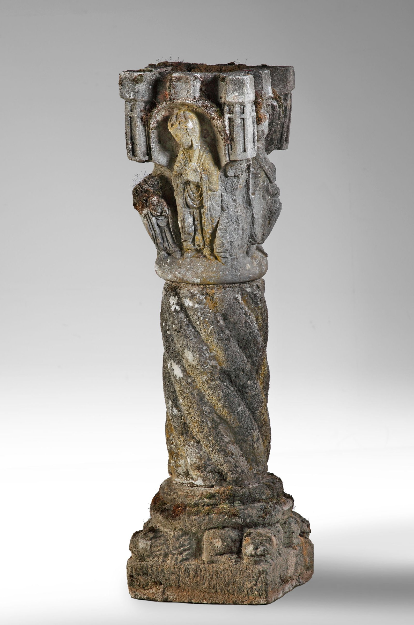 A CONTINENTAL COMPOSITION STONE JARDINIERE, LATE 19TH-EARLY 20TH CENTURY: The square section hollow top above a relief cast figure to each side, the Solomonic stem and circular socle on zoomorphic supports and square base. Height 97 cm, 27 cm. square.