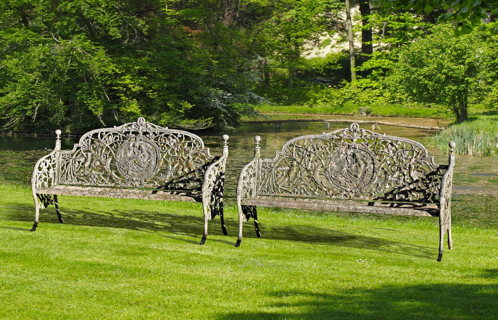 A PAIR OF CONTINENTAL CAST IRON GARDEN BENCHES IN 19TH CENTURY STYLE MID 20TH CENTURY, AFTER THE (1 of 2)