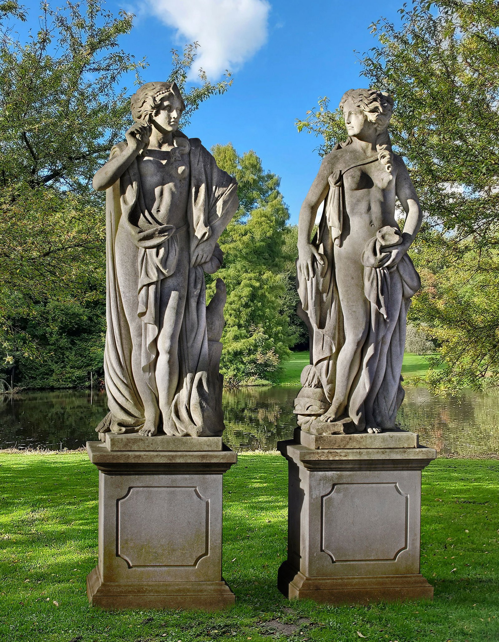 A PAIR OF SCULPTED LIMESTONE LIFESIZE FIGURES OF MINERVA AND JUNO, LATE 20TH CENTURY: Each Goddess portrayed partially draped, standing and with an attribute; Juno with a peacock, and Minerva her helmet. Height each 180 cm. Each stood atop a panel sided pedestal, height 80 cm., width 7