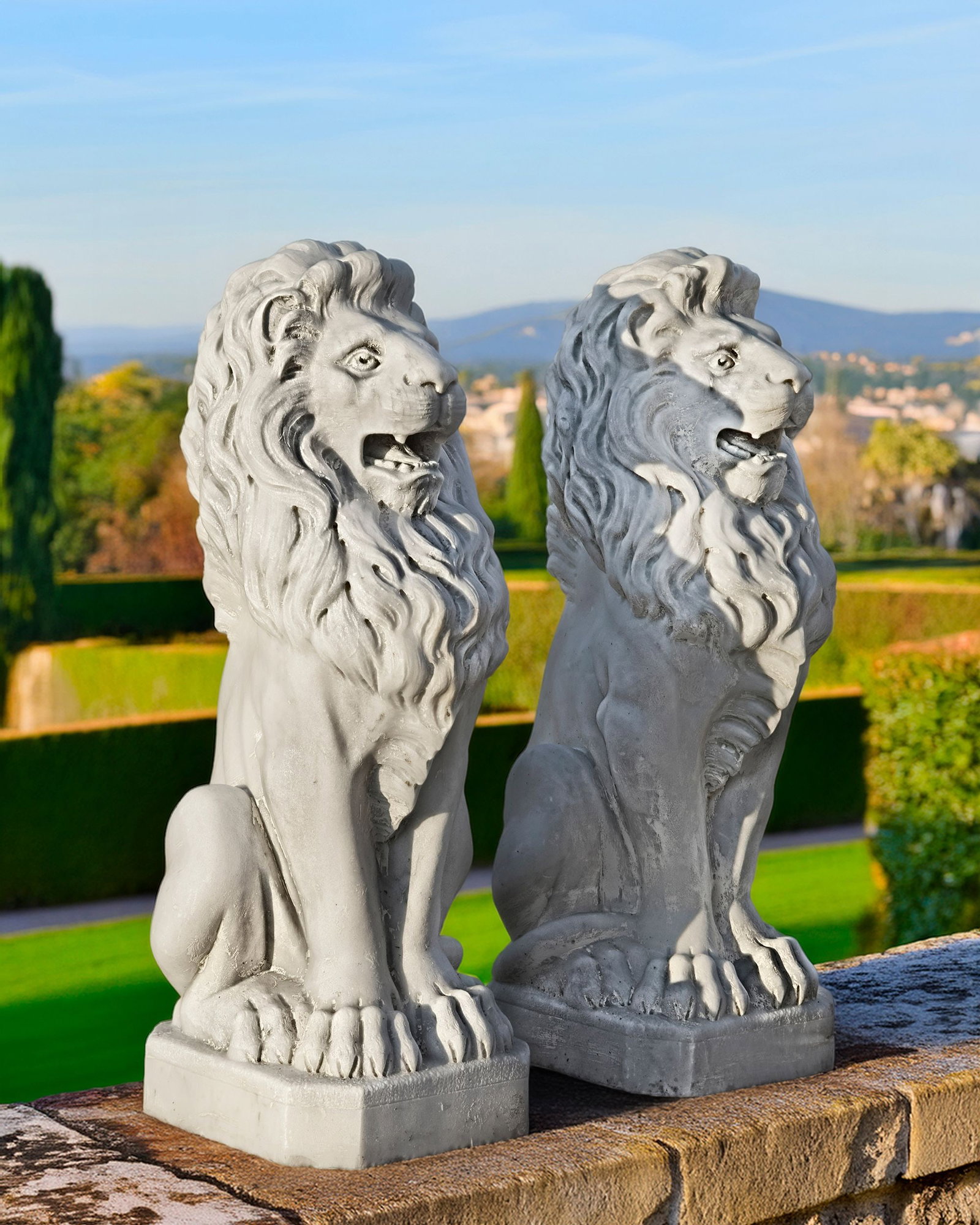 A PAIR OF ITALIAN SCULPTED WHITE MARBLE MODELS OF SEATED LIONS, PROBABLY LATE 19TH CENTURY: Modelled sitting upright and with mouths agape. Height each 79 cm. Width 28 cm. Depth at the bases 30 cm.