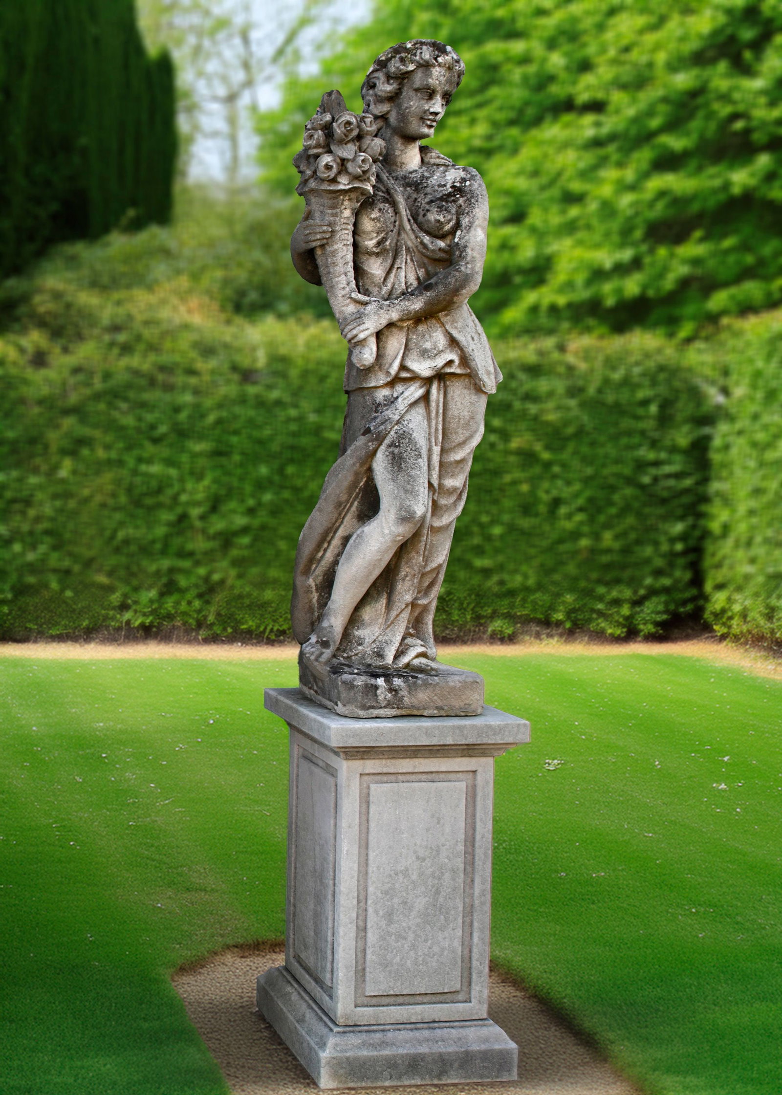 A CONTINENTAL SCULPTED LIMESTONE MODEL OF FORTUNA: The horn of abundance is an ancient symbol that stands for infinite wealth and food. Height overall 232 cm. Base 80 by 45 by 45 cm.
