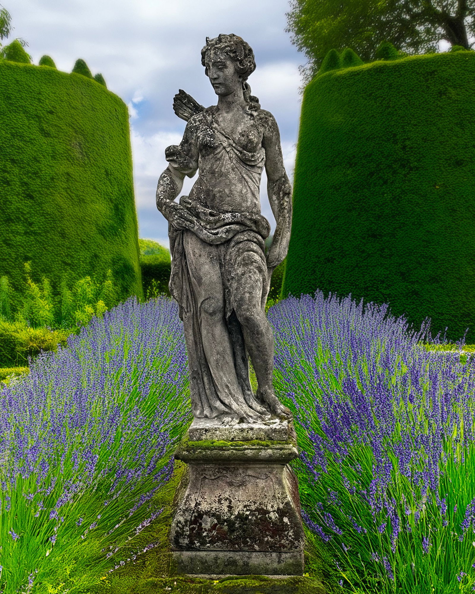 A SCULPTED LIMESTONE MODEL OF DIANA, LATE 19TH CENTURY: Portrayed with classical attributes, 17 cm height. Atop tapering square section plinth height 46 cm and 47 cm. square at the base. Height overall 221 cm.
