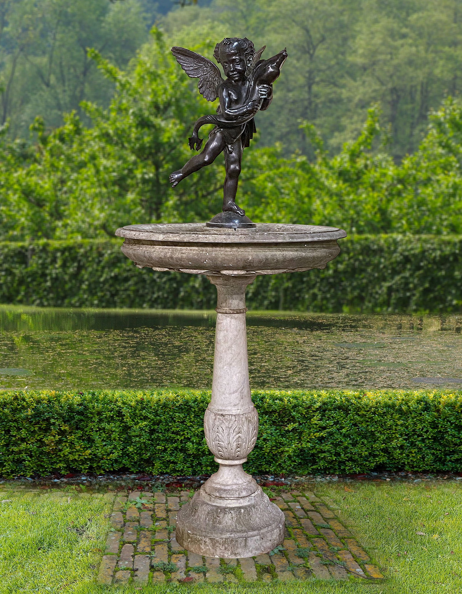 A FLORENTINE CARVED MARBLE AND BRONZE MOUNTED FOUNTAIN, LATE 19TH CENTURY: Of dished, pedestal form, with acanthus carving to the underside of the basin and the vase of stem, the whole surmounted by a bronze figural spout modelled as a cherub and dolphin, the water issuing f