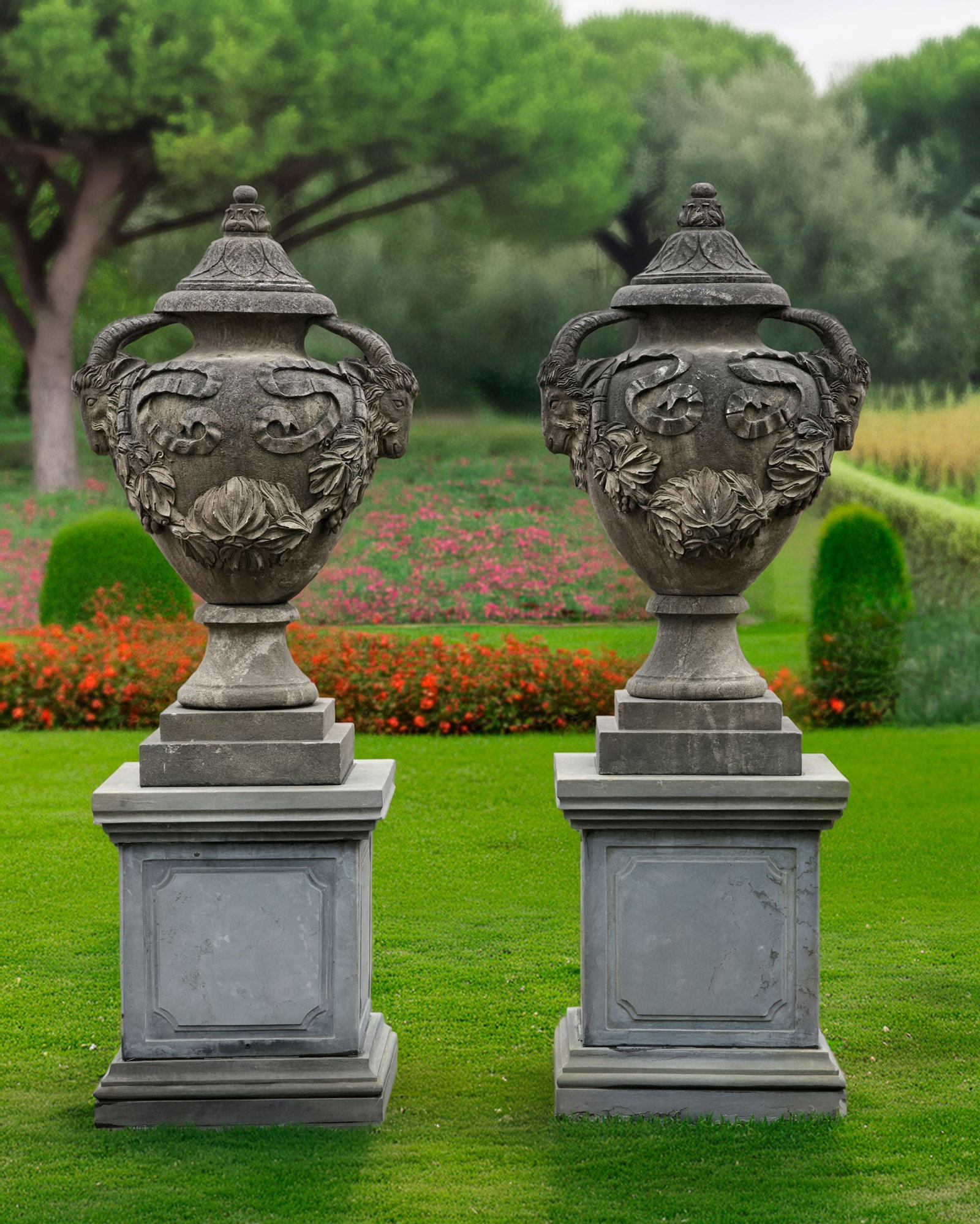 A PAIR OF LARGE SCULPTED CLASSIC GARDEN URNS WITH LID, 20TH CENTURY: These monumental vases with amphora shape, a wide belly, a narrow foot, and a lid on top. On both sides are rams head, the horns extend upwards, forming the handle that curves toward the rim of the va