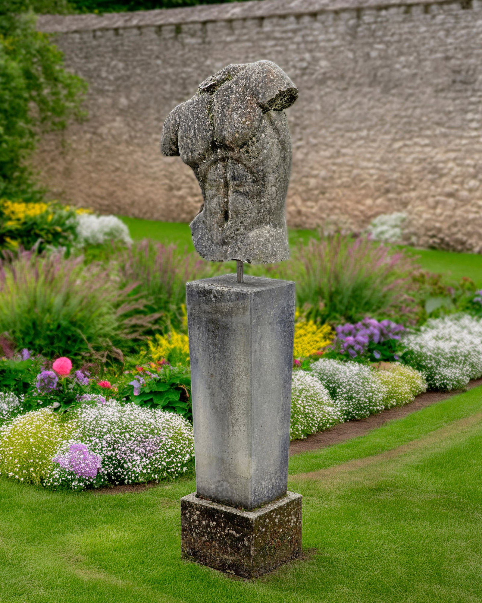 A LIMESTONE SCULPTED MALE TORSO: Overall height 158 cm.