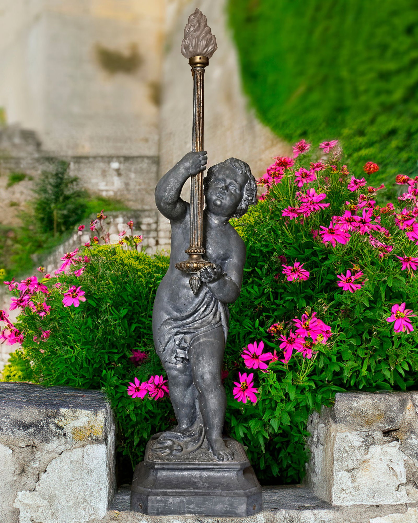 A DUTCH CAST ZINC FIGURE OF A PUTTO HOLDING A TORCHERE, 19TH CENTURY, STAMPED ADRIANUS GODSCHALK: Height 150 cm.