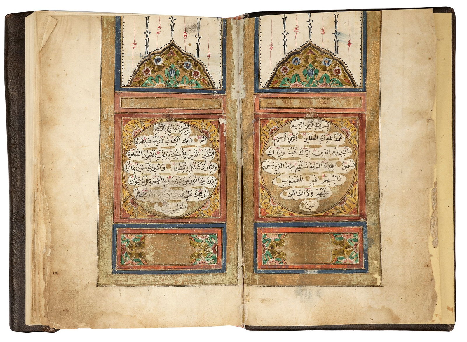 AN ILLUMINATED OTTOMAN QURAN, TURKEY, BY OSMAN IBN HASAN AL-BADI, DATED 1247 AH/1831 AD: A complete Quran, Arabic manuscript on paper, 15 lines to each page in bold black naskh script within a gilt and black border. Two opening biofolia with polychrome and gilt decoration framing 7ll. Gol