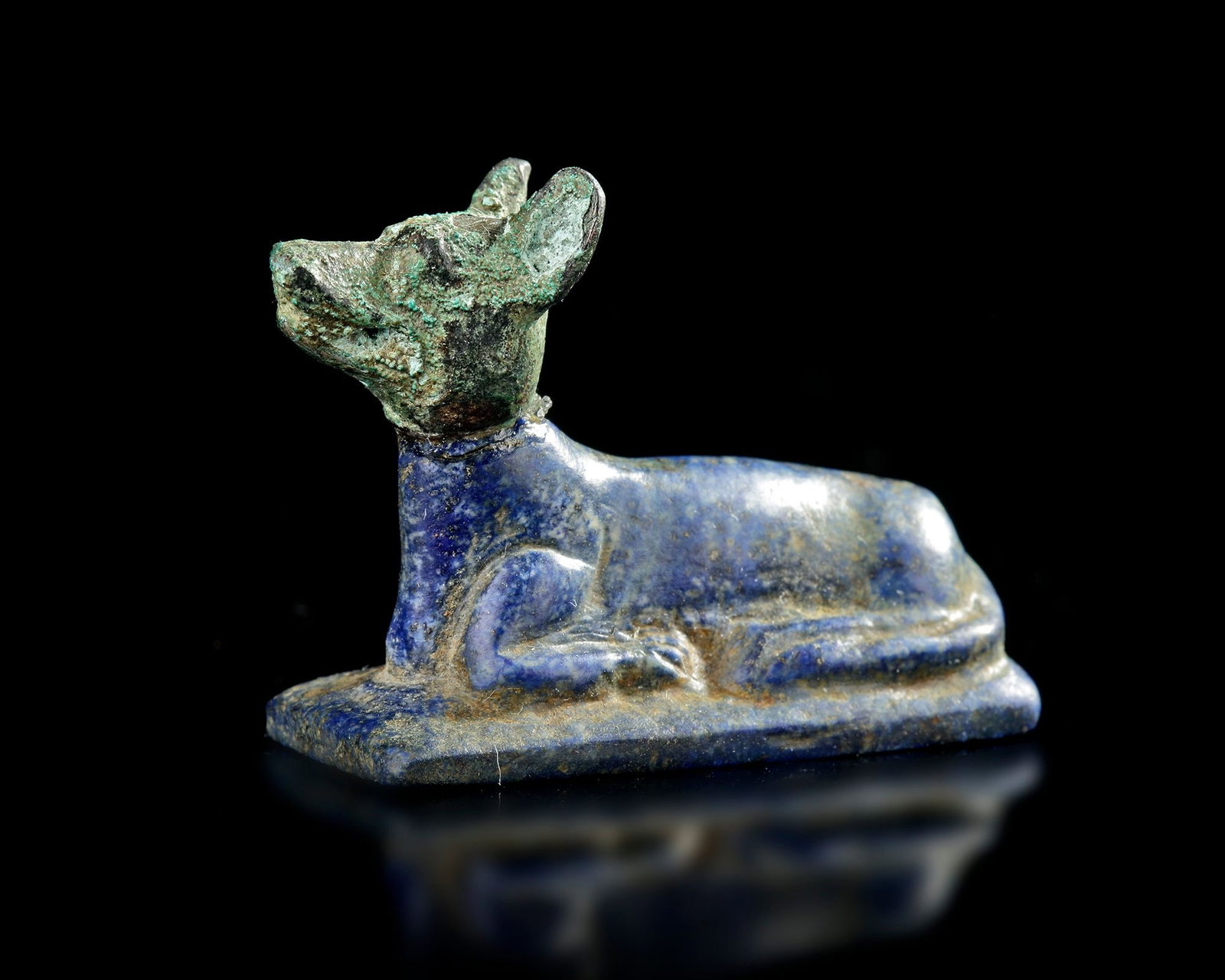 A LAPIS LAZULI RECUMBENT JACKAL, LATE PTOLEMAIC-ROMAN PERIOD, CIRCA 200 BC-100 AD (1 of 2)