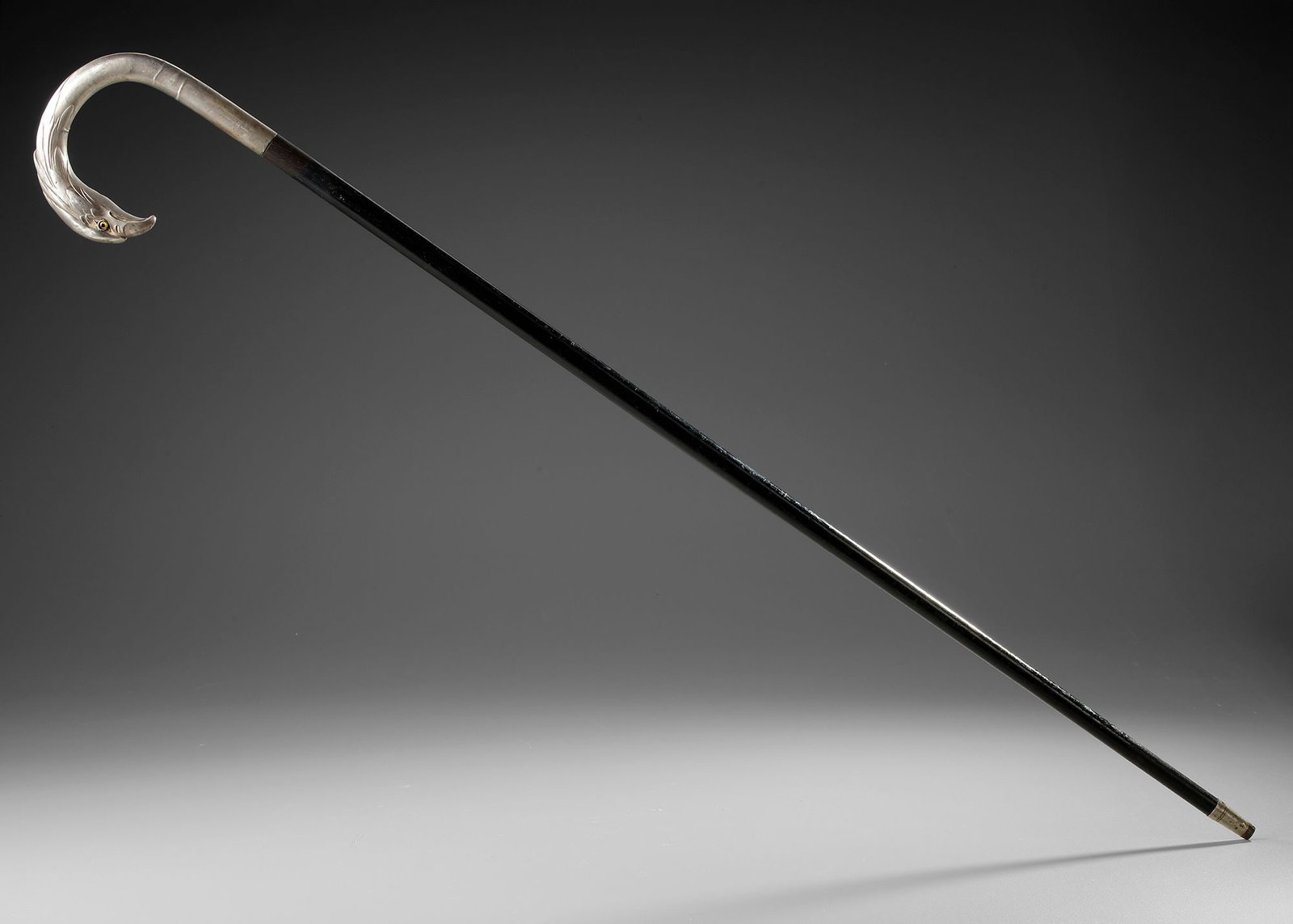 A SILVER-MOUNTED BLACK WOOD WALKING CANE WITH BIRD-HEAD HANDLE (1 of 3)