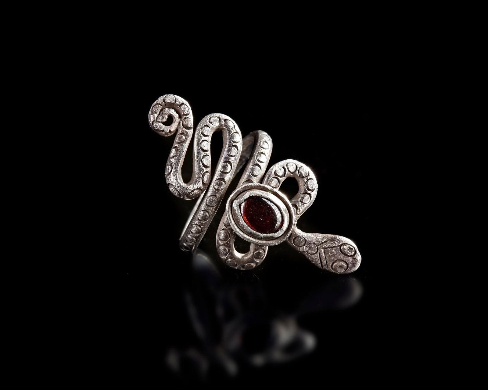 AN ANCIENT ROMAN SILVER RING SET WITH A RED STONE, 2NDâ€“3RD CENTURY AD (1 of 3)