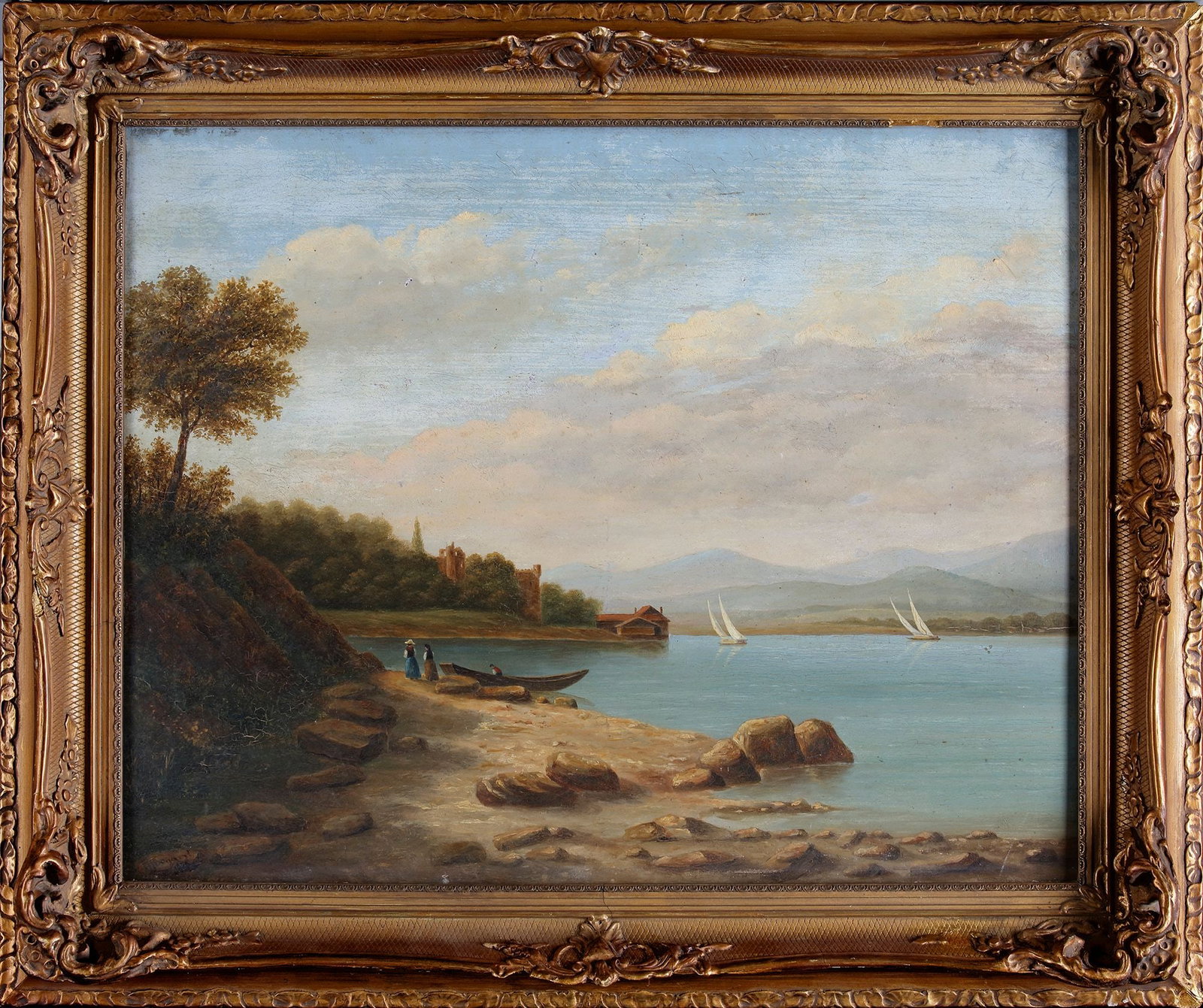 AN OIL PAINTING, SIGNED J. BOGAERT 1879: A serene 19th-century landscape showing a peaceful lakeshore with boats, figures, distant mountains, and a castle ruin, painted with warm tones and fine atmospheric detail. With frame 59 by 49 cm.