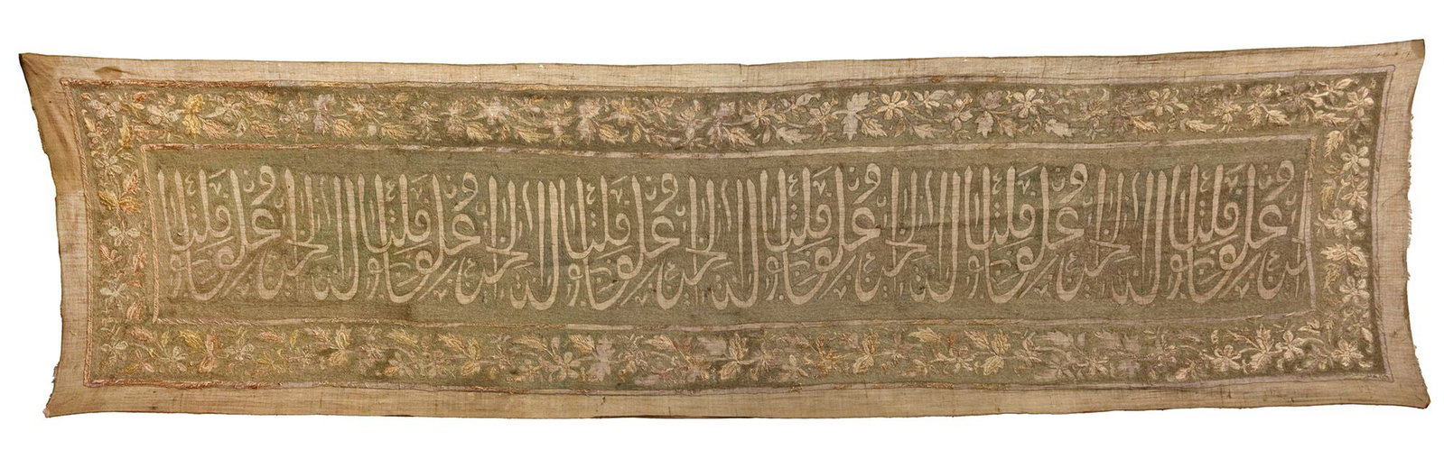 AN OTTOMAN CALLIGRAPHIC EMBROIDERED MIHRAB BAND, TURKEY, LATE 19TH CENTURY: A large Ottoman Mihrab mosque band, possibly originating from Istanbul or Bursa, finely worked on a cotton ground and richly embroidered with thick silver zari threads. The central field is inscribed 